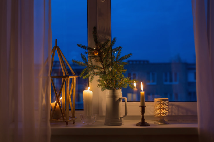 Candles and other decor on a windowsill.